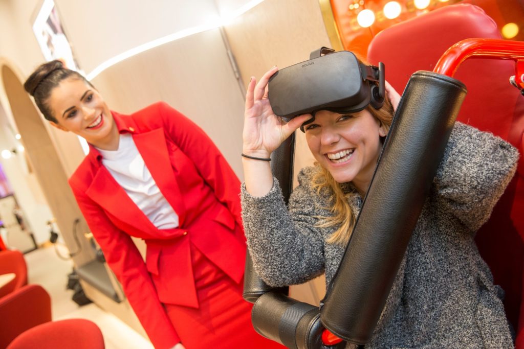 2 women smiling, one women wearing VR headset