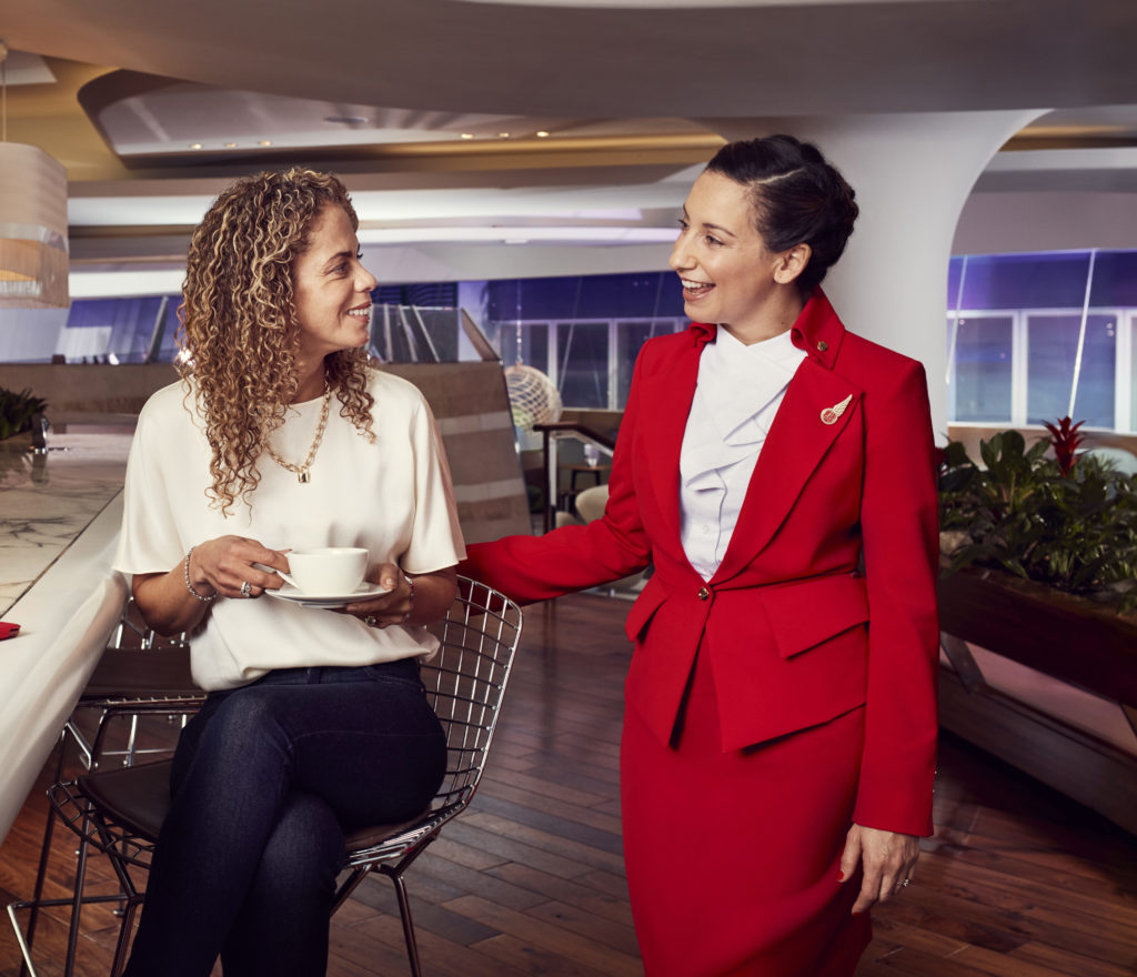 Virgin Atlantic Clubhouse employee interacting with guest in the lounge