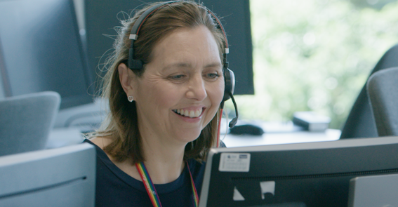 Crawley customer centre employee smiling with headset on.