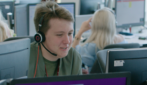 Close up of Crawley customer centre employee with a headset on.