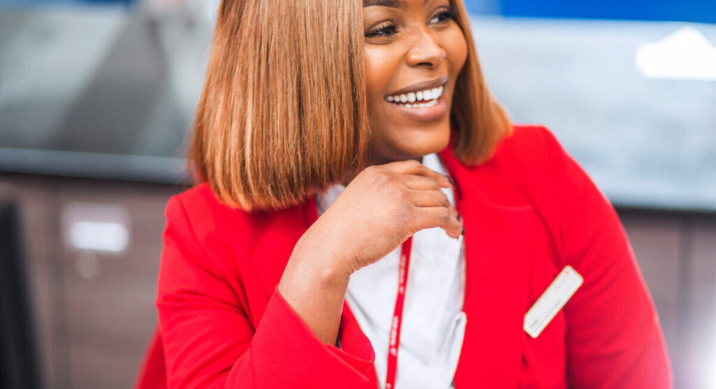 Virgin Atlantic Employee at her desk smiling