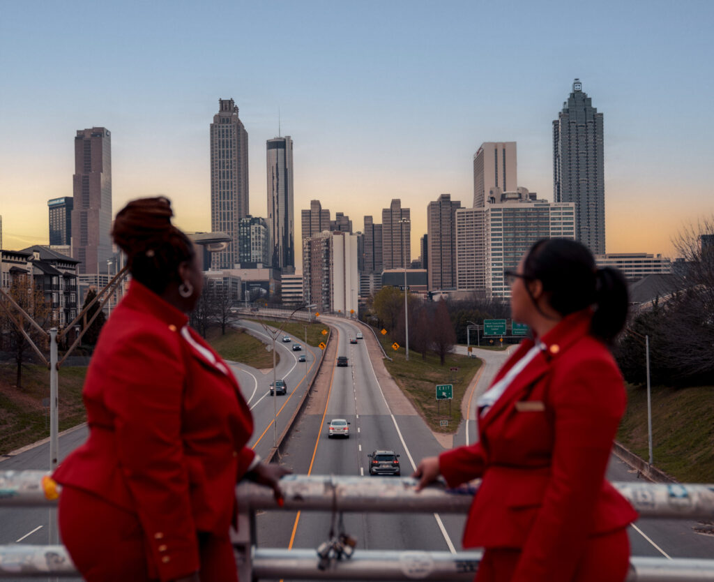 Two Virgin Atlantic employees looking out over the Atlanta cityscape