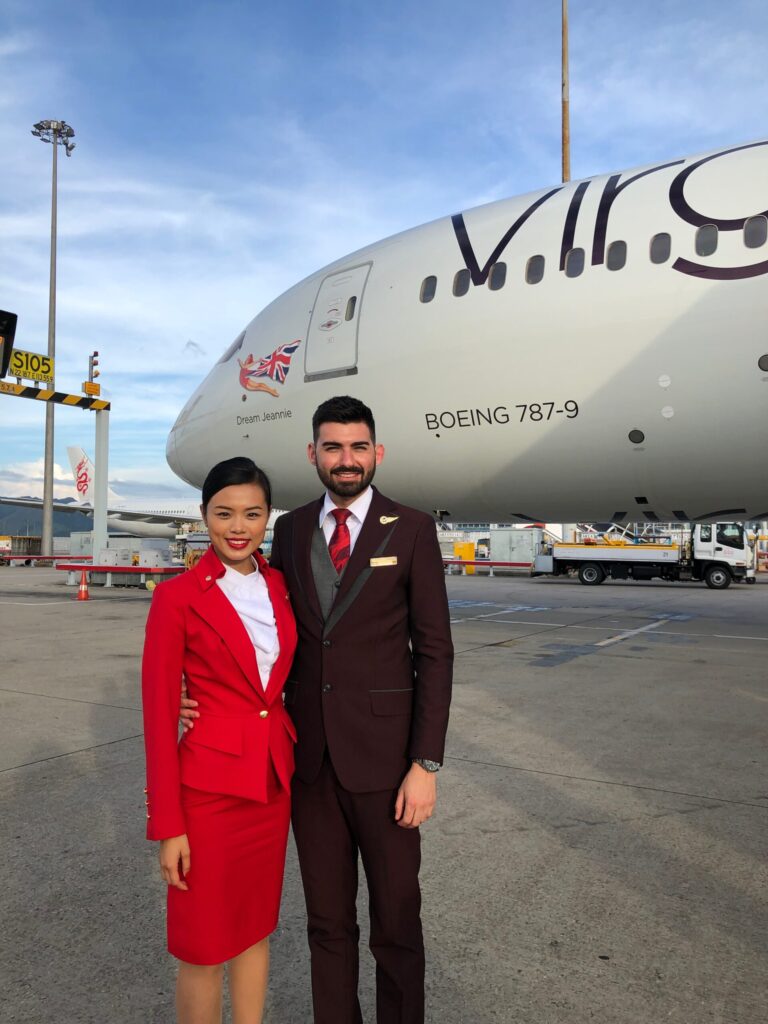Two Virgin Atlantic Cabin Crew at the airport standing in front of a B787